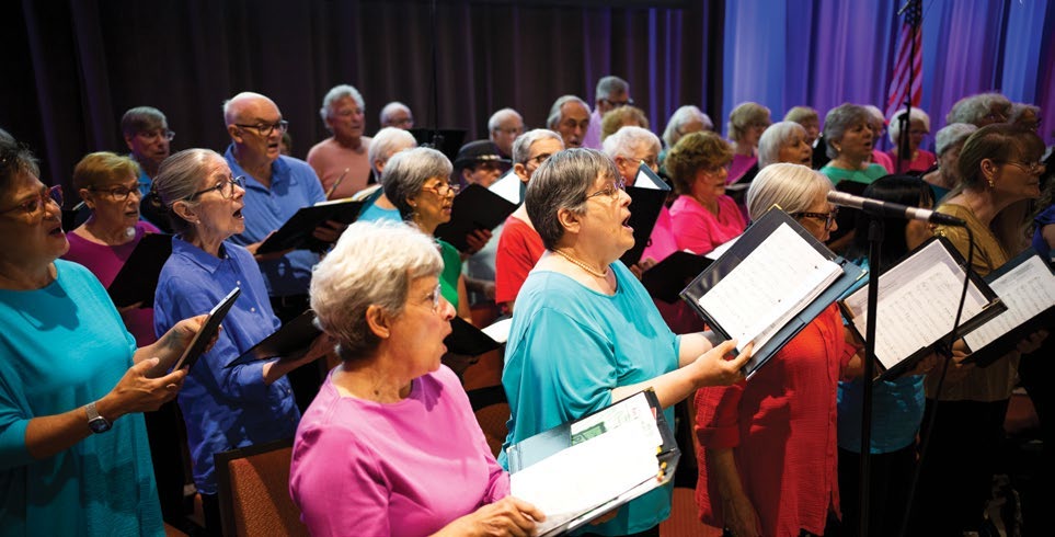 A choir performing, pictured in the Dementia Friendly America section of the report